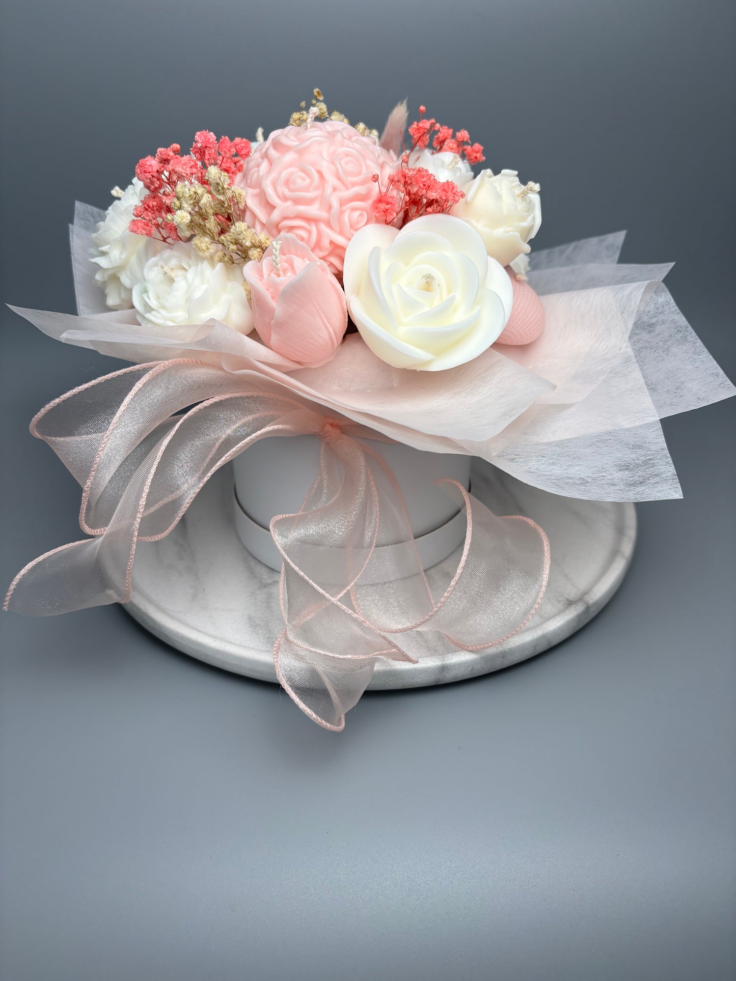 Bouquet of wax flowers with pink and white flowers, side view showing height
